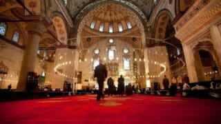 Muslim men praying inside the Blue Mosque