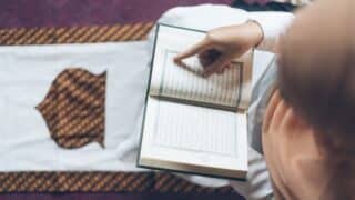 Woman in Hijab Reading a Quran