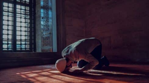 a man praying in a Mosque