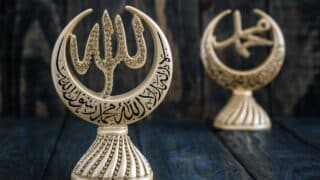 Decorative items with crescent shapes, Arabic calligraphy Allah and Mohamed gold color, rhinestones, wood background.