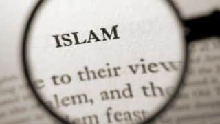 Word "Islam" magnified by a lens with blurred surrounding text.