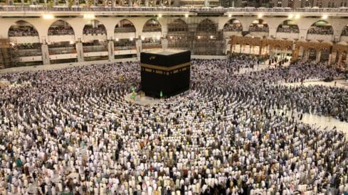 The honorable Kaaba in Mecca is surrounded by a large gathering of worshipers at the Grand Mosque.