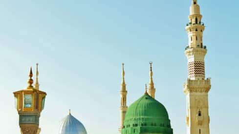 prophet Mosque view with green dome, minarets, and decorative structure under clear blue sky