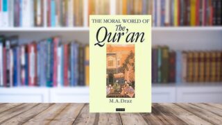 Book titled "The Moral World of The Qur'an" by M.A. Draz displayed on a wooden table, with a blurred background of bookshelves filled with various books.